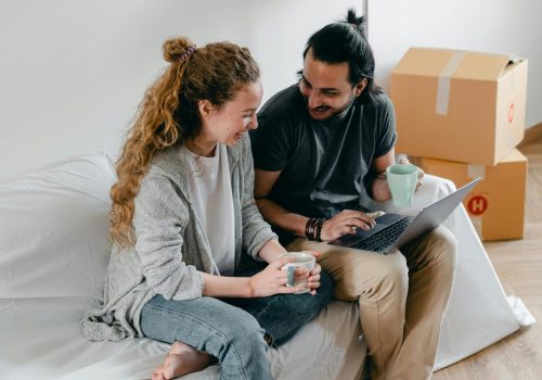 Couple sitting at home working through the online downloadable pre marital counselling booklet.