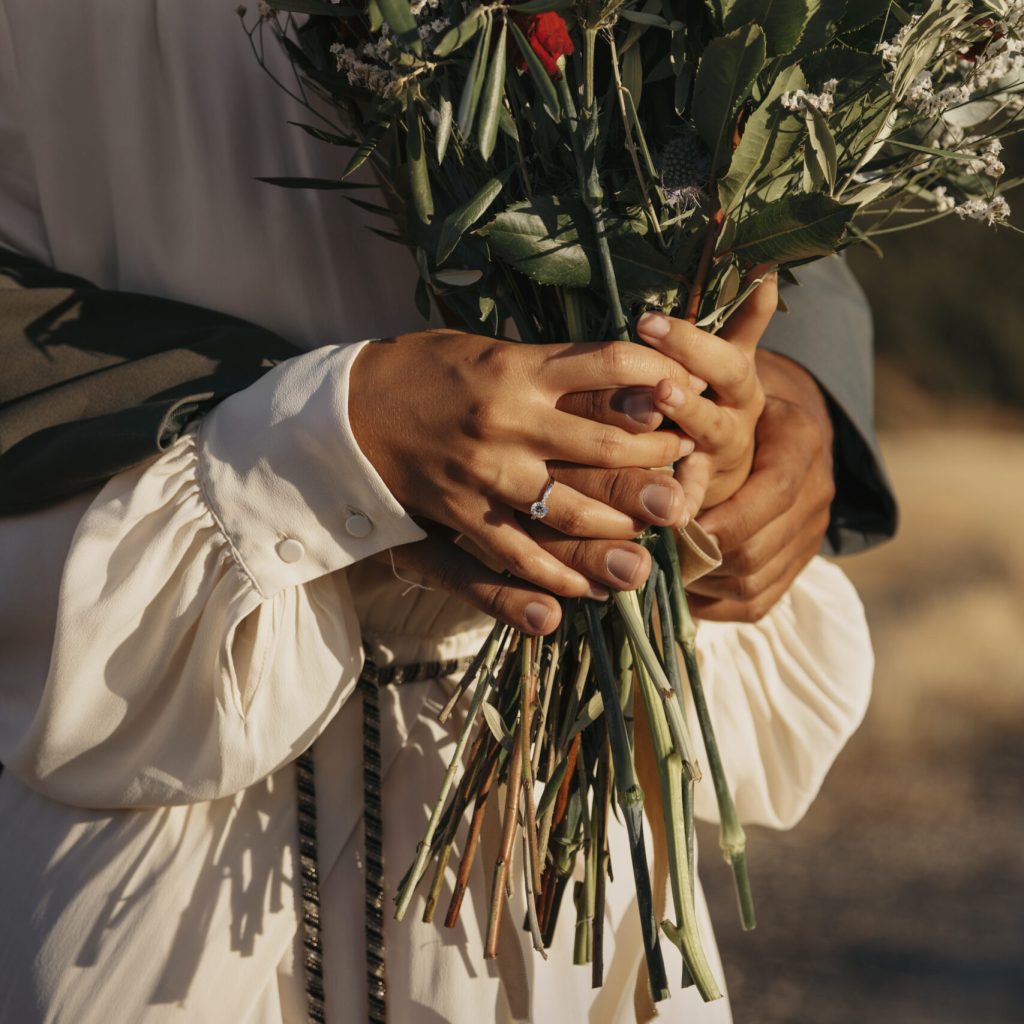 Coloured Couple standing with flowers at their wedding after completing their Pre Marital Counselling Program.